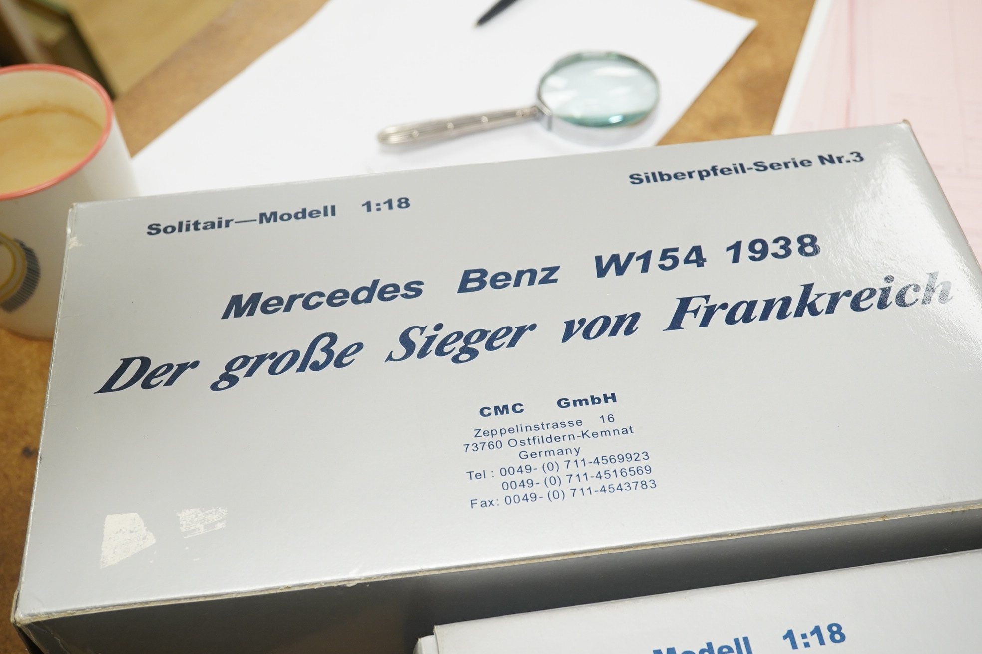 Two boxed CMC 1:18 scale diecast model cars; a Mercedes-Benz W196, together with a Mercedes-Benz W154 1938. Condition - fair to good, and slight metal fatiguing to the bonnet on the W196 as occasionally found with early